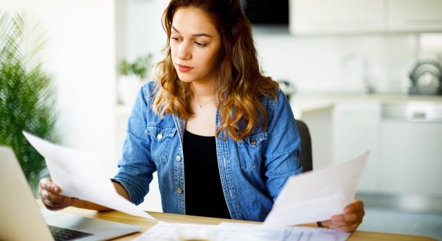 Young woman reviewing her car insurance declarations page