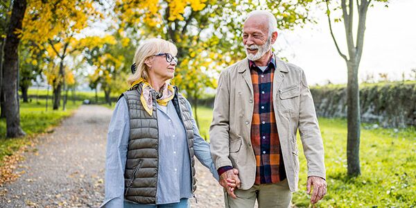A man and woman walking in a park