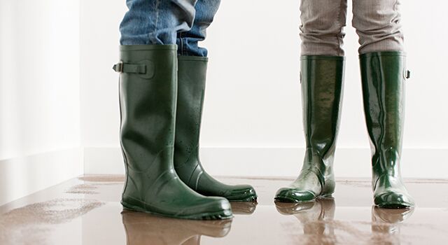 Two people standing in a flooded room