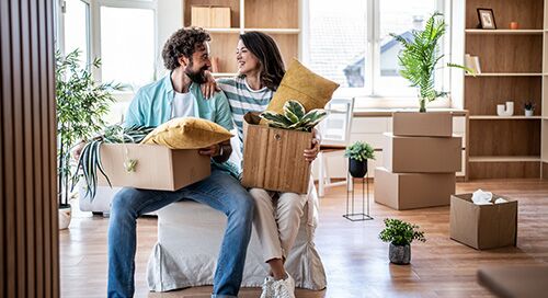 Man and woman unpacking their move in a new condo